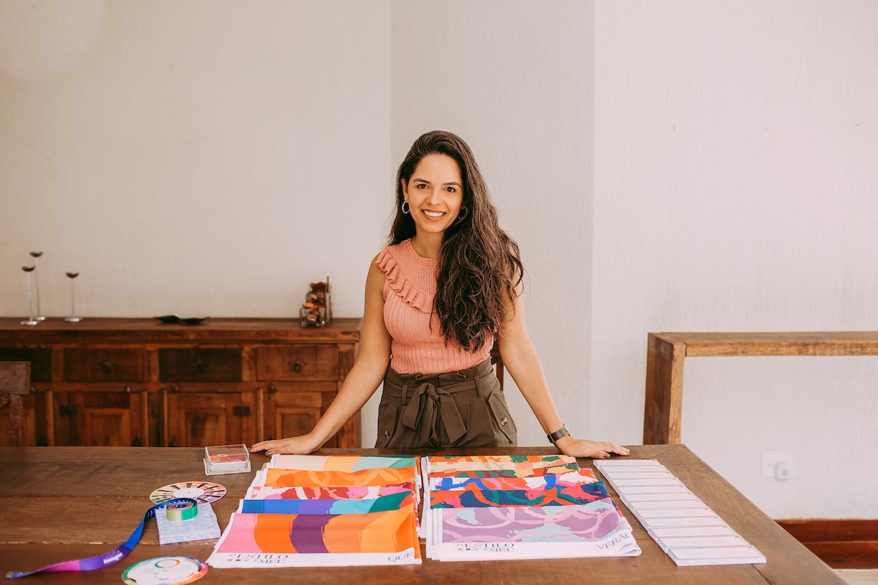 Interior designer stands at table with samples